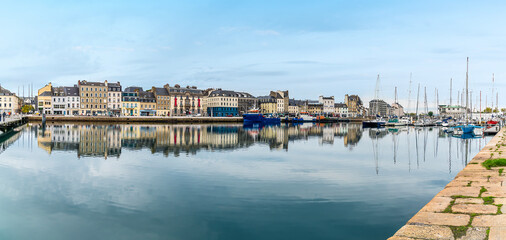 Obraz premium A panorama view of reflections in the water of the inner harbor at Cherbourg, France in autumn