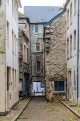 Fototapeta premium A view down a quaint narrow alleyway at Cherbourg, France in autumn