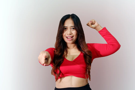 Beautiful Asian woman wearing sportswear smiling cheerfully and pointing to camera.