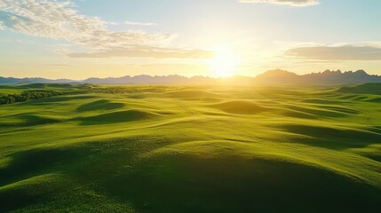 Fototapeta premium Aerial Footage of Vast Green Landscape Captured by Drone at Sunset
