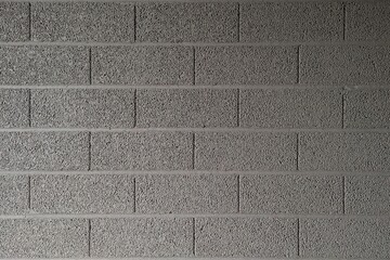 Wall of expanded clay concrete blocks. Gray background.