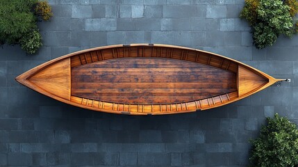 Overhead view of an empty wooden rowboat on a stone surface.