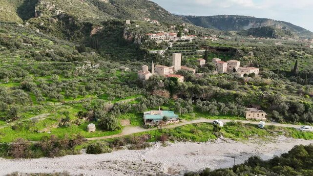 Aerial view of Mourtzinos Tower and Church of St. Spyridon during sunset in the town of Kardamyli on the Mani Peninsula, Greece.