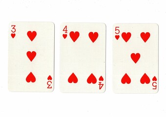 A hand of playing cards showing a run of three on a white background.