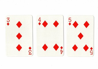 A hand of playing cards showing a run of three on a white background.