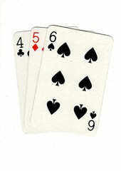 A hand of playing cards showing a run of three on a white background.