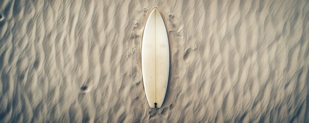Obraz premium Surfboard on rippled sand beach - serenity and adventure combined