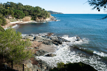 Coastal landscape near the town of Cavalaire in the south of France. Coastal path with views of the Mediterranean sea, hills covered by a forest of maritime pines.