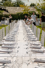 Served wedding table with plates, white chairs, napkins and wine glasses