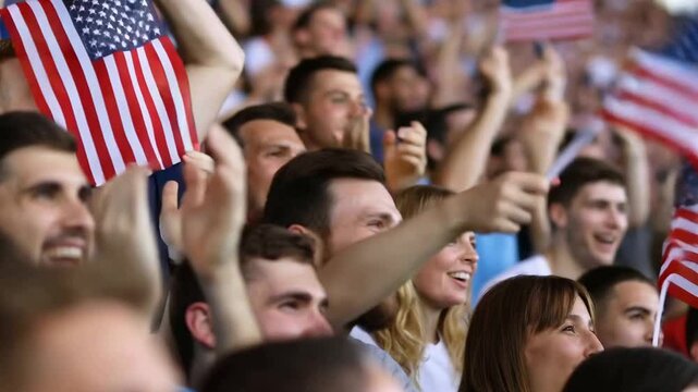 American sports fans cheering with flags in the stadium during a match
