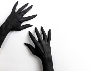 The woman hands with long nails painted in black color.