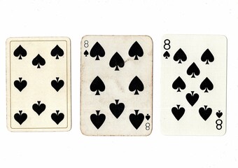 Vintage playing cards in three different designs showing the same value.