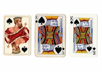 Three vintage playing cards of the same vale in different designs on a white background.