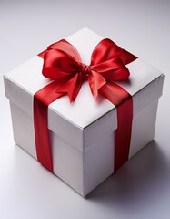 Fototapeta premium Caja de regalo Blanca, con un lazo rojo en las esquinas fondo blanco neutro