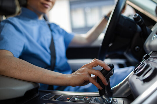 Asian nurse driving car and shifting gear
