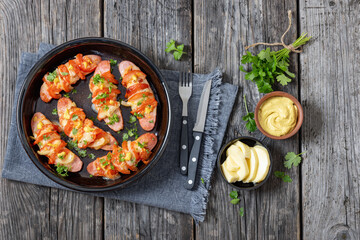 hot sausages baked with cheese, tomato, mustard