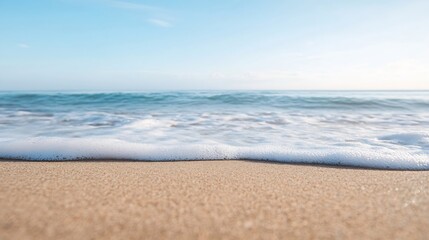 Obraz premium Calm beach shoreline with gentle waves washing onto warm golden sand under a clear blue sky : Generative AI