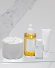 Beauty products for facial skin care on marble background. Serum, moisturizing cream and toner. Mockup.