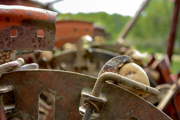Mechanical device for planting potato tubers, close-up. Potato layer is a technical means used in mechanized planting of potatoes. Close-up of engineering thought. Potato-layer is a little rusty.