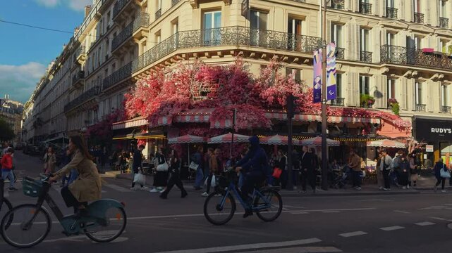 Parisian Cafe with Floral Decor and Busy Street Scene