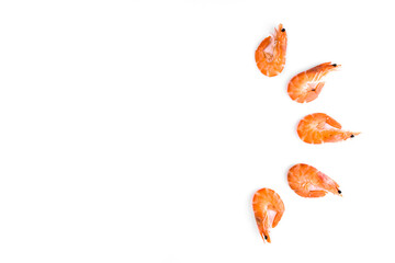 boiled shrimp with a bright orange shell laid out on a white background