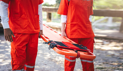 Rescue operations team responding to urgent accident scene with coordinated effort, paramedics...