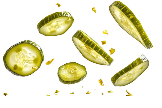 Isolated falling pickled cucumber slices captured on a clean white surface.