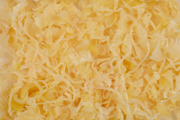 A close-up shot of sliced sauerkraut, showcasing its texture and light color