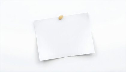  Blank white note pinned to a white surface, slightly off-center placement