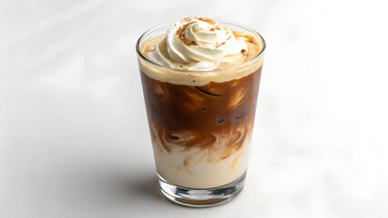 A photo of an iced coffee with cream on top. The coffee is in a glass on a white background.