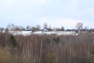 An old village on a mountain in the forests of northeastern Europe in mid-May