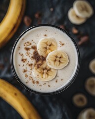 Delicious banana smoothie topped with sliced fruit and spices