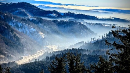 mountains in fog during winter © Marcin