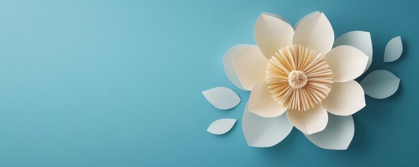 Papercraft cream flower on blue background with leaves