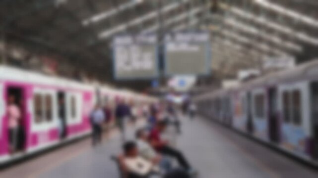 Blurred view of the platform with passengers and trains at Chhatrapati Shivaji Maharaj Terminus in Mumbai, India.