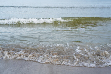 Sandy shore of the Baltic Sea with waves