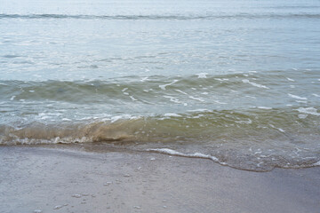 Sandy shore of the Baltic Sea with waves