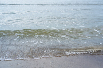 Sandy shore of the Baltic Sea with waves