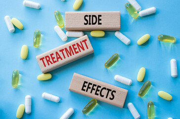 Side Treatment Effects symbol. Concept words Side Treatment Effects on wooden blocks. Beautiful blue background with pills. Healthcare and Side Treatment Effects concept. Copy space.