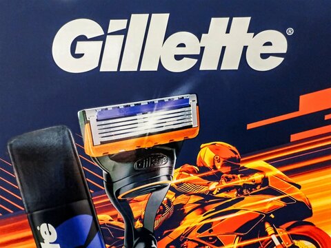 Gillette razor is displayed next to a colorful image of a motorcyclist, conveying energy and efficiency in grooming products. Gomel, Belarus - February 15, 2025