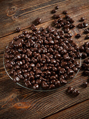 Chocolates on a brown wooden background.