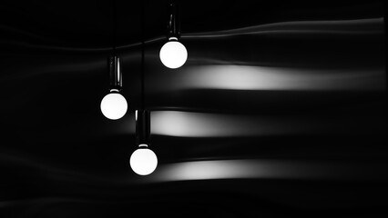 Three white light bulbs hanging from the ceiling. The bulbs are lit up and the room is dark