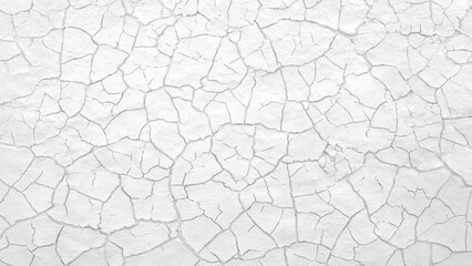 image is a close up of a wall with many cracks and holes. The wall appears to be old and worn down,...