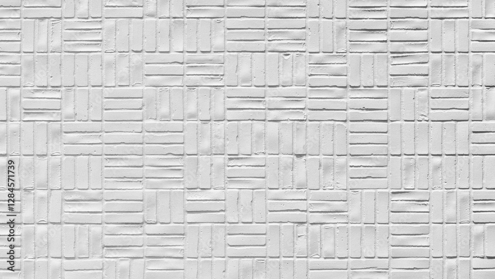 Poster wall is made of white bricks and has a unique pattern of squares. The bricks are arranged in a way that creates a visually interesting design. The wall appears to be made of cement