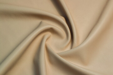 beige artificial leather with waves and folds on PVC base