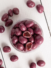 Dried fruits or dried berries in chocolate glaze. Sweets in a glass jar.