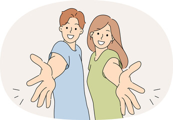 Welcoming gesture made by man and woman inviting you to visit or wanting to hug friends. Happy couple extends hands towards screen in greeting, sharing positive emotions and desire to be friends