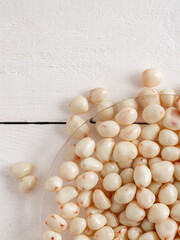 Dried fruits in white milk chocolate. Candies on a wooden background.