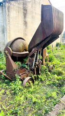 Abandoned Rusty Concrete Mixer in Overgrown Field