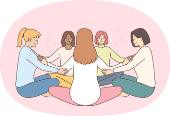 Group meditation of women sitting in circle in lotus position and holding hands during team psychotherapy session. Multiracial girls use group meditation and yoga practices to achieve nirvana